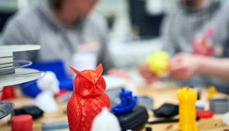 Yrittäjät katsovat pöydällä olevia 3D-tulosteita.