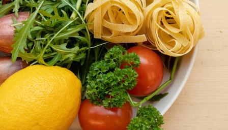 Kasviksia ja pastaa lautasella lähikuvassa.