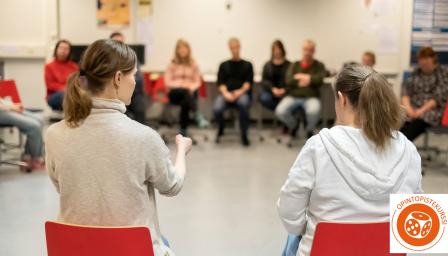 Ihmiset ringissä keskustelemassa työväenopiston tunnilla