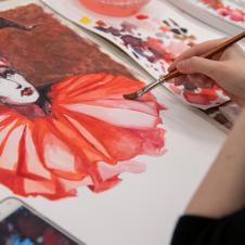 Taidepajan opiskelija maalaa vesiväreillä.